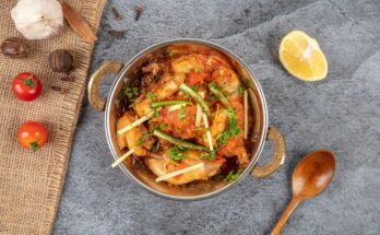 Hot and spicy chicken karahi served in a traditional wok with naan – Lahore street food.