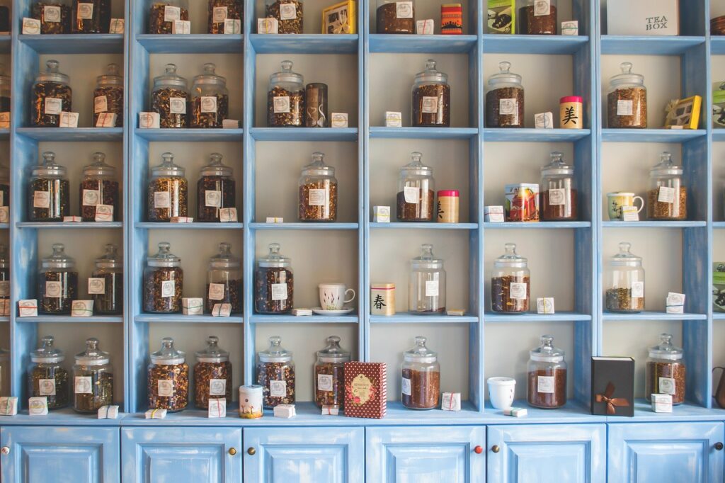A traditional herbal store in Lahore with shelves of herbal medicine and a shopkeeper preparing remedies.