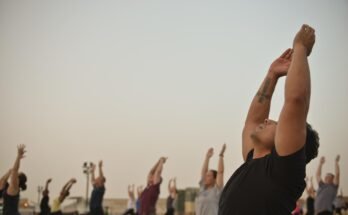 Affordable yoga class in Lahore with people doing stretches in a peaceful studio.