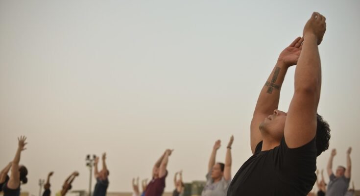 Affordable yoga class in Lahore with people doing stretches in a peaceful studio.