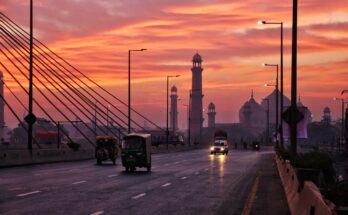 Narrow street in Walled City Lahore filled with people and heritage buildings