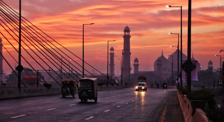 Narrow street in Walled City Lahore filled with people and heritage buildings