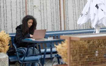 Students studying on laptops in a Lahore café with fast Wi-Fi.